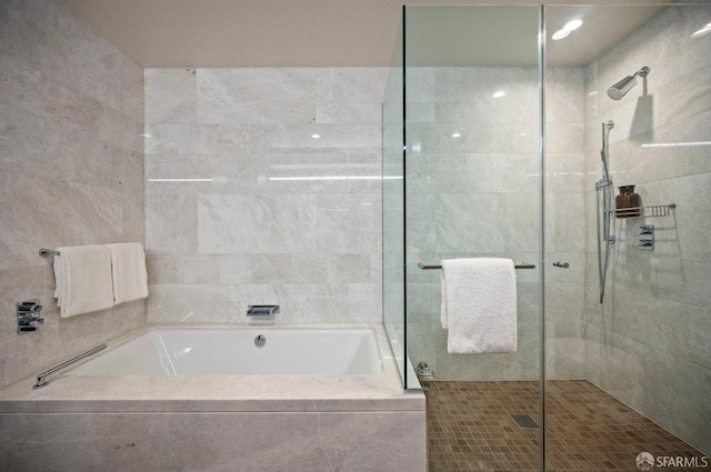 bathroom featuring separate shower and tub