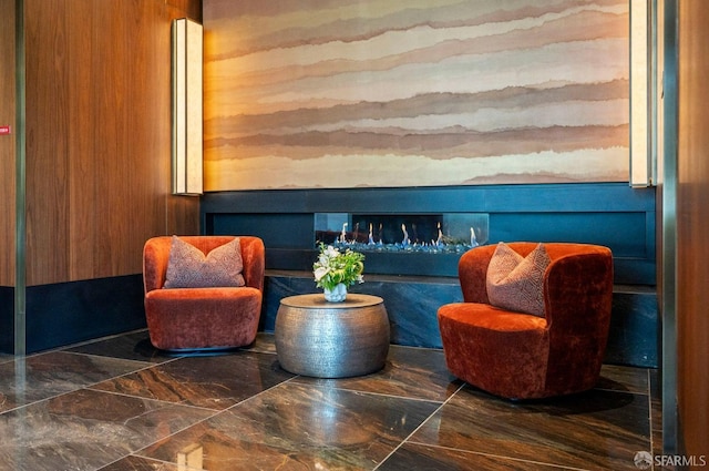 sitting room featuring wooden walls