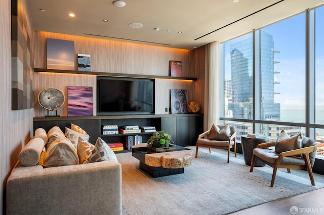 living room with a wealth of natural light, hardwood / wood-style flooring, and expansive windows