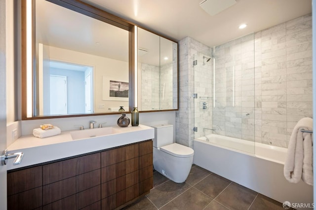 full bathroom featuring toilet, tile patterned flooring, tiled shower / bath, and vanity