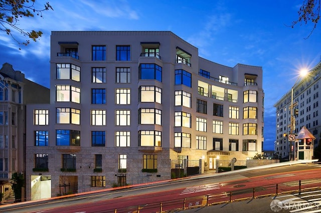 view of outdoor building at dusk