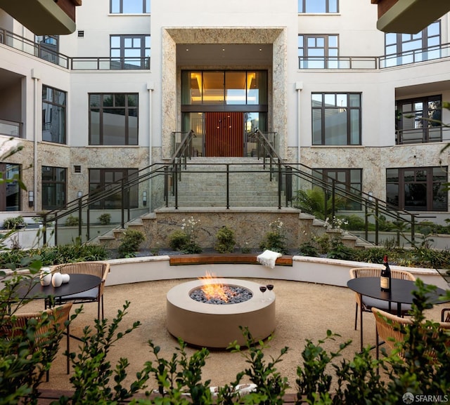 surrounding community featuring a patio and a fire pit