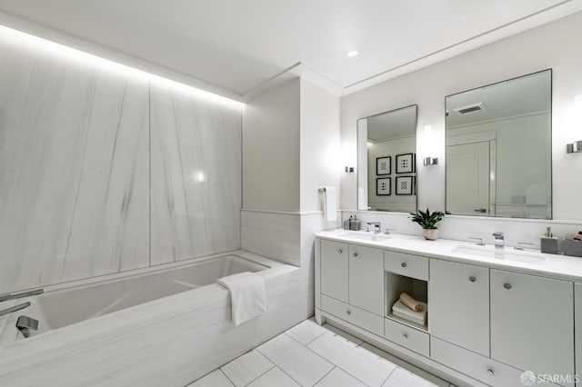 bathroom with tile patterned floors, vanity, ornamental molding, and a washtub