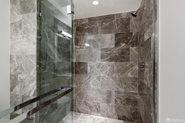 bathroom with a shower with shower door