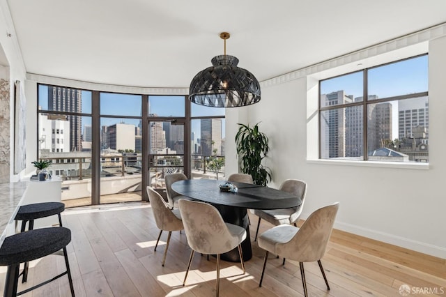 dining space with light wood-type flooring