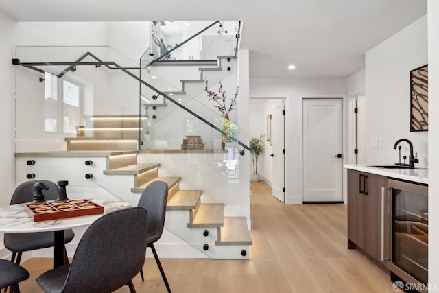867 33rd Ave, San Francisco, CA 94121 - dining space with wine cooler, stairs, light wood finished floors, bar with sink, and recessed lighting
