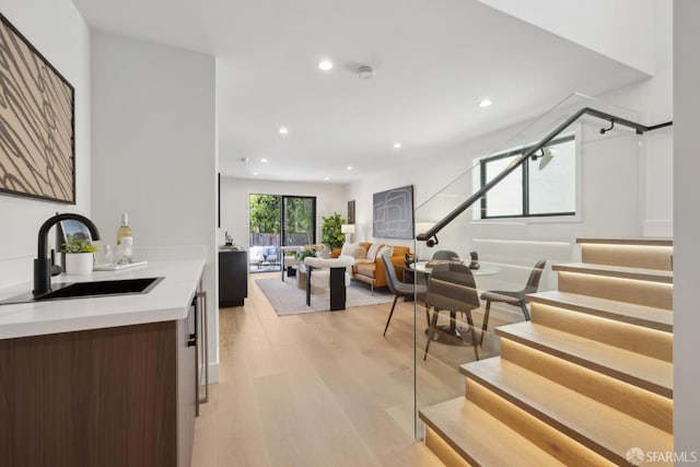 867 33rd Ave, San Francisco, CA 94121 - dining area featuring stairs, light wood-style flooring, recessed lighting, and bar with sink