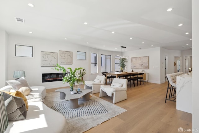 867 33rd Ave, San Francisco, CA 94121 - living area featuring recessed lighting, light wood-style floors, a glass covered fireplace, and baseboards