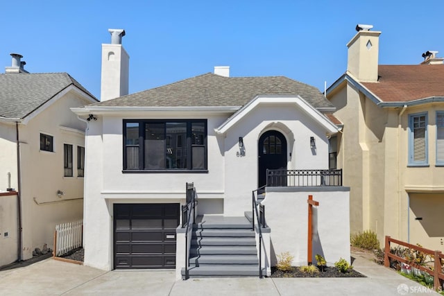 867 33rd Ave, San Francisco, CA 94121 - view of front of property featuring a garage, stucco siding, concrete driveway, and a chimney