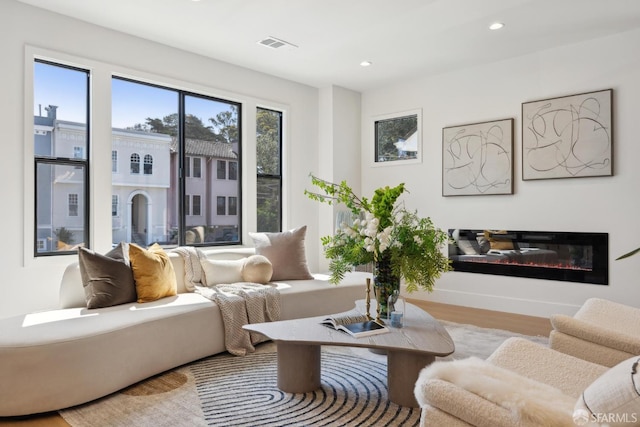 867 33rd Ave, San Francisco, CA 94121 - living room featuring a glass covered fireplace, recessed lighting, and wood finished floors