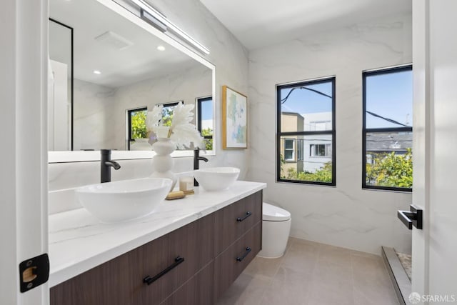 867 33rd Ave, San Francisco, CA 94121 - bathroom featuring healthy amount of natural light, double vanity, and toilet