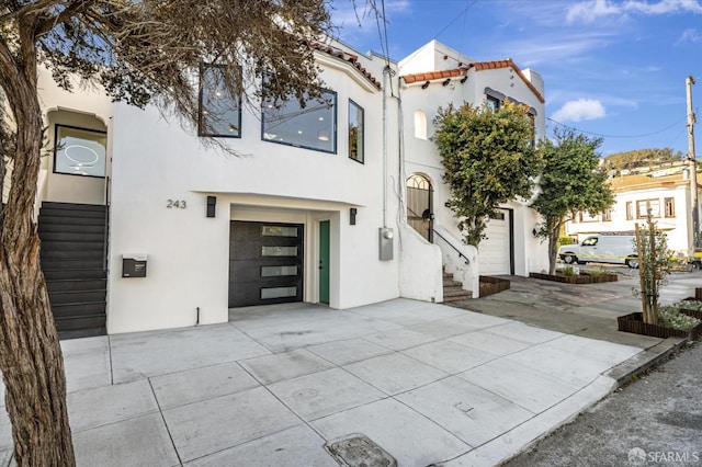 mediterranean / spanish home featuring a garage