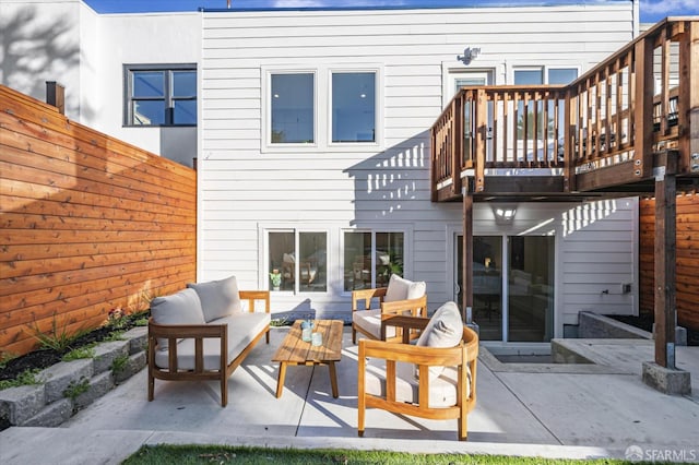 rear view of house with outdoor lounge area and a patio