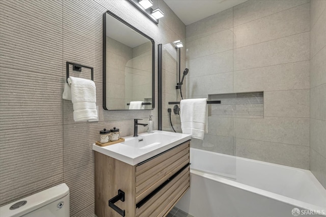 full bathroom featuring vanity, tasteful backsplash, shower / bath combination, toilet, and tile walls