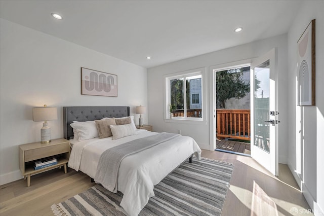 bedroom with light wood-type flooring and access to exterior