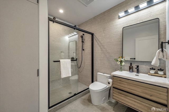 bathroom with tile patterned flooring, vanity, decorative backsplash, toilet, and walk in shower