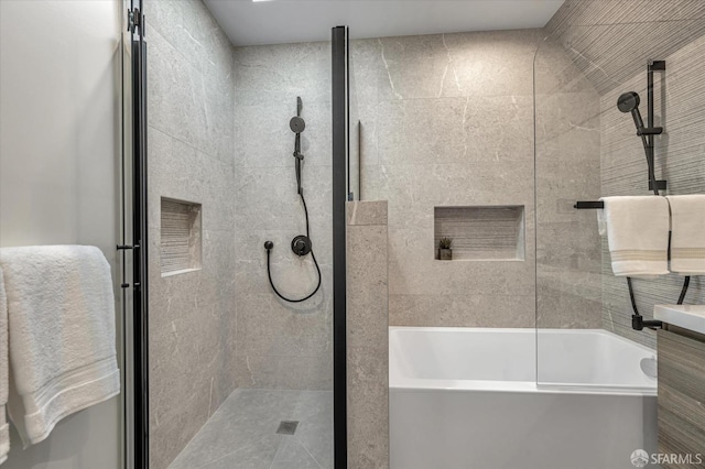 bathroom featuring vanity and independent shower and bath