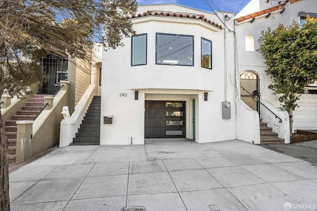 mediterranean / spanish home featuring a garage