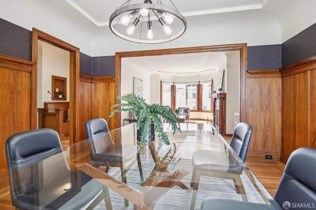 dining area with wood finished floors and a chandelier