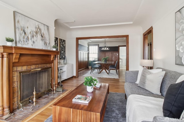 living area with a tiled fireplace and wood finished floors