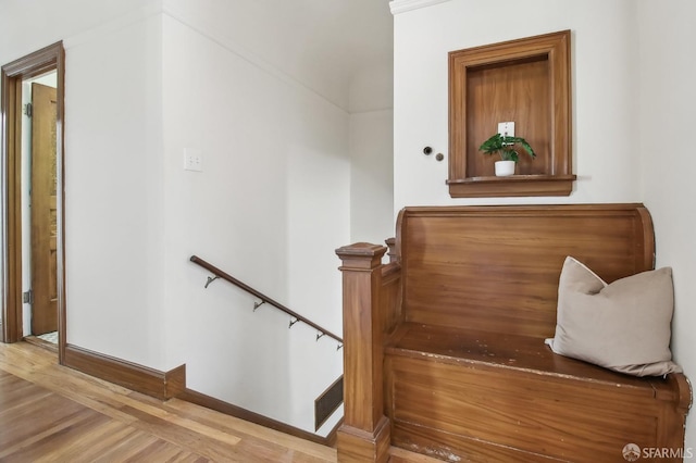 stairs with baseboards and wood finished floors