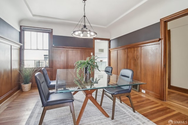 dining area featuring baseboards, light wood finished floors, and visible vents