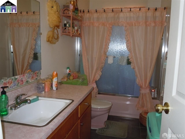 full bathroom featuring shower / tub combo with curtain, tile patterned flooring, vanity, and toilet