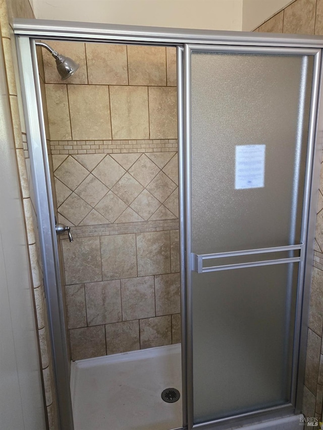 bathroom featuring a shower stall
