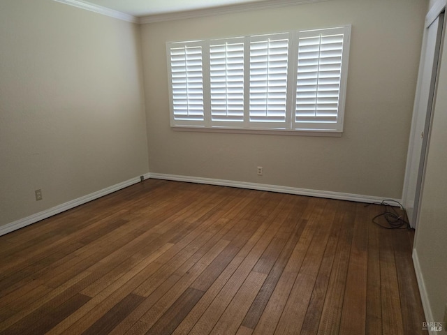 unfurnished room with crown molding, baseboards, and hardwood / wood-style floors