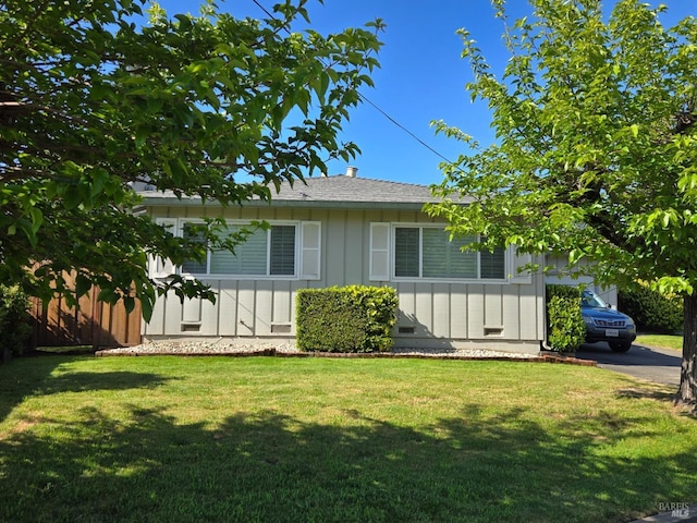 view of home's exterior with a lawn and board and batten siding