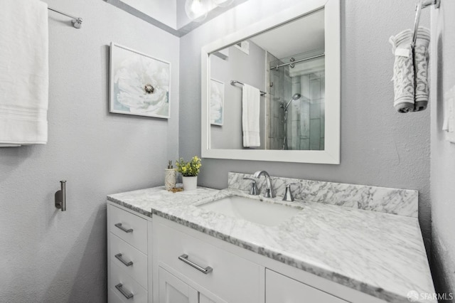 bathroom featuring vanity and a shower