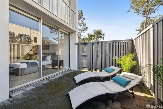 view of patio featuring a balcony