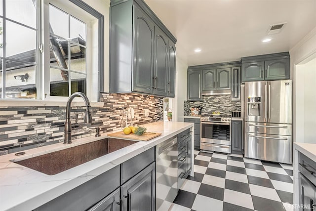 718 Whipple Ave, Redwood City, CA 94063 - kitchen with appliances with stainless steel finishes, a sink, dark floors, tasteful backsplash, and light stone countertops