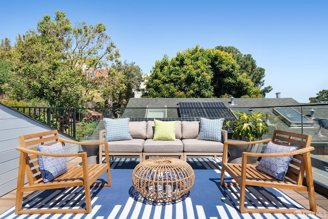 wooden terrace with an outdoor living space