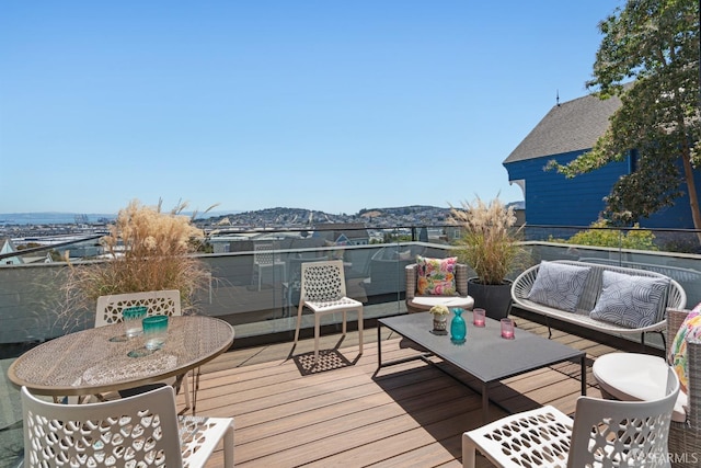 wooden terrace featuring an outdoor living space and a mountain view