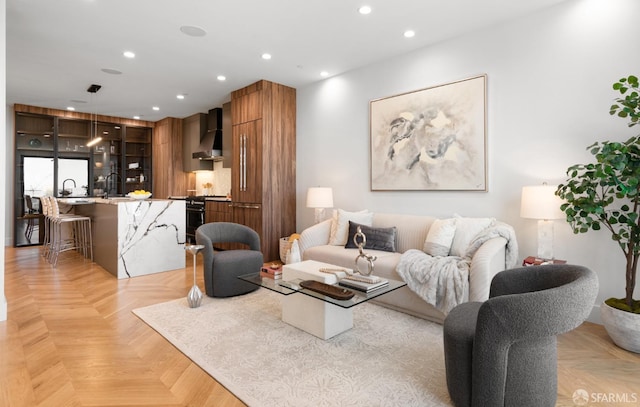 living room featuring light parquet floors and sink