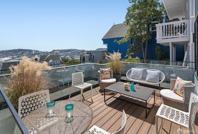 deck with a mountain view and outdoor lounge area