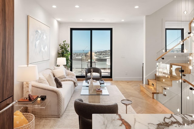 living room featuring a healthy amount of sunlight and light parquet flooring