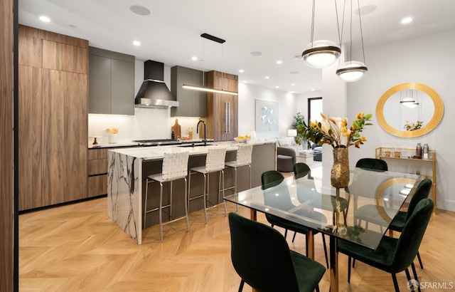 dining space with light parquet flooring and sink