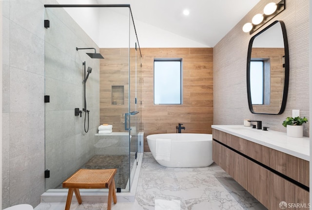 bathroom featuring plenty of natural light, separate shower and tub, vaulted ceiling, and vanity