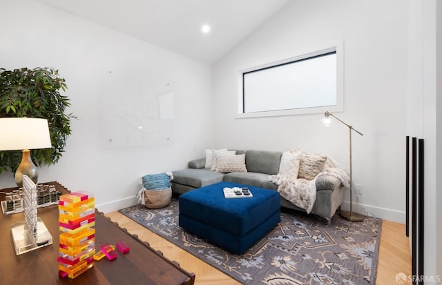 living room with hardwood / wood-style flooring and lofted ceiling