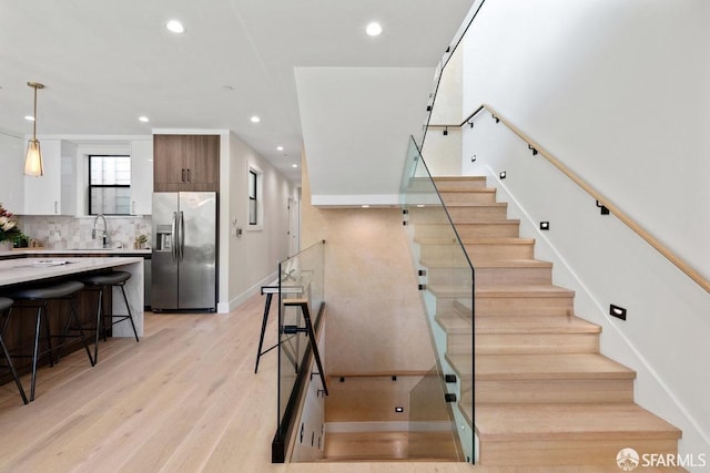 2219 Bryant St, San Francisco, CA 94110 - staircase with sink and wood-type flooring