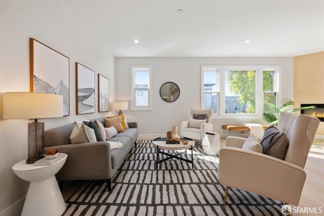 2219 Bryant St, San Francisco, CA 94110 - living room with light hardwood / wood-style floors and a large fireplace