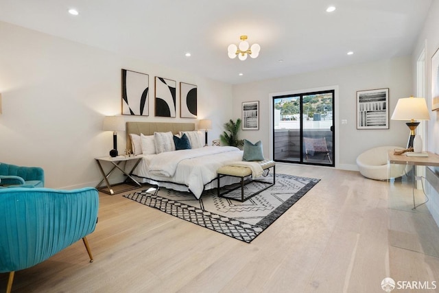2219 Bryant St, San Francisco, CA 94110 - bedroom featuring wood-type flooring, access to exterior, and a notable chandelier