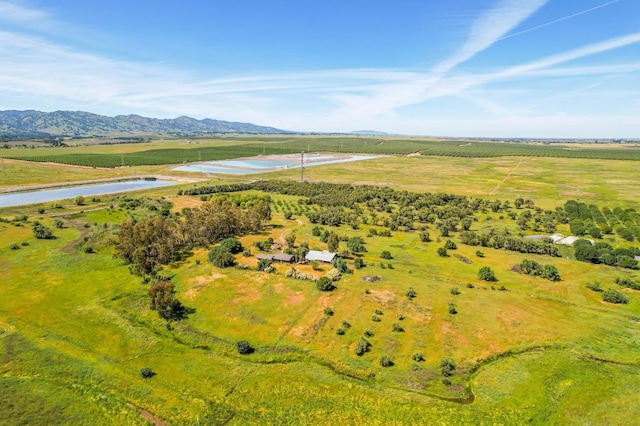 aerial view featuring a water and mountain view and a rural view