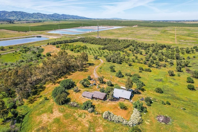 aerial view with a water and mountain view and a rural view