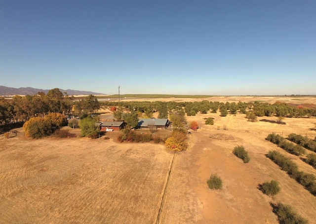 drone / aerial view featuring a mountain view and a rural view