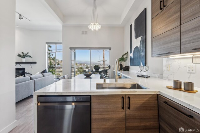 608 Missouri St Unit A, San Francisco, CA 94107 - kitchen with stainless steel dishwasher, a sink, a peninsula, open floor plan, and light stone counters
