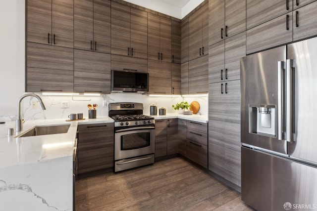 608 Missouri St Unit A, San Francisco, CA 94107 - kitchen featuring appliances with stainless steel finishes, a sink, dark wood-type flooring, light stone countertops, and modern cabinets