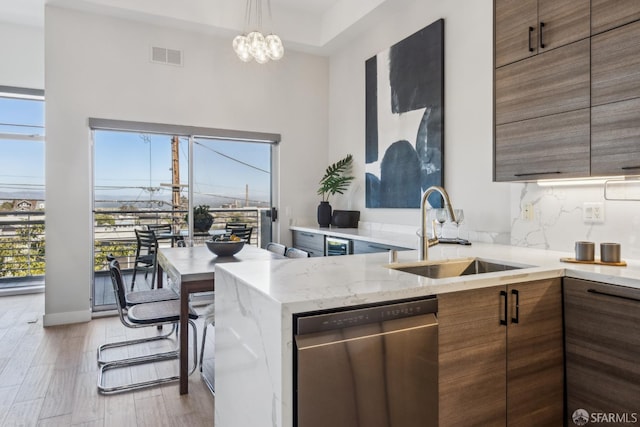 608 Missouri St Unit A, San Francisco, CA 94107 - kitchen featuring dishwasher, a sink, a high ceiling, light stone counters, and brown cabinetry